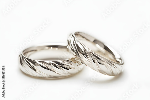 A pair of silver wedding rings with a polished finish, on a white background.