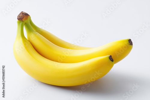 Three ripe bananas, arranged slightly overlapping.  Their yellow skin is smooth and glossy, with hints of brown at the stems.  They are positioned on a bright white background