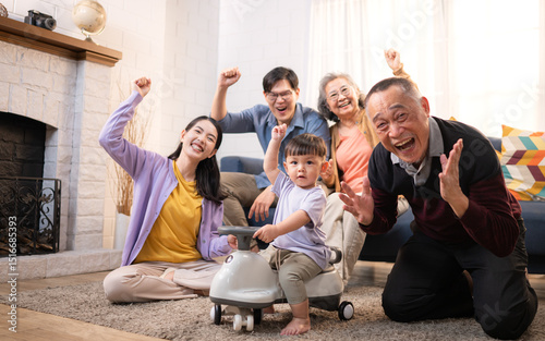 Happy multi-generational Asian family enjoying quality time together at home