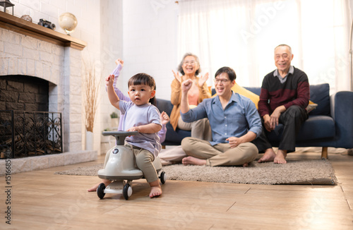 Happy multi-generational Asian family enjoying quality time together at home