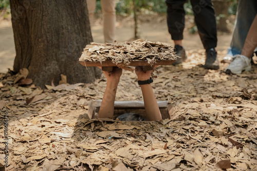 Cu Chi Tunnels. Tourists try to enter the underground tunnels. These tunnels were used in the Vietnam war. Famous tourist attractions in Vietnam