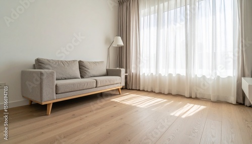 a cozy living room featuring wooden flooring a minimalist couch and natural light filtering through soft curtains