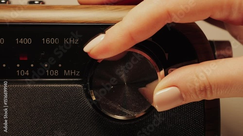 Close-up of a radio dial. A hand turns the tuning knob. Tuning a radio station frequency. High quality 4k footage
