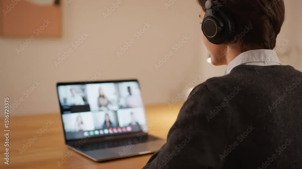 Person on Video Call with Headphones at Home Office