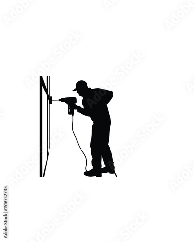 Silhouette of a worker using a power drill on wall on white background