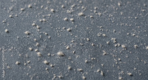 Close-up of fabric with pilling on blue textile surface