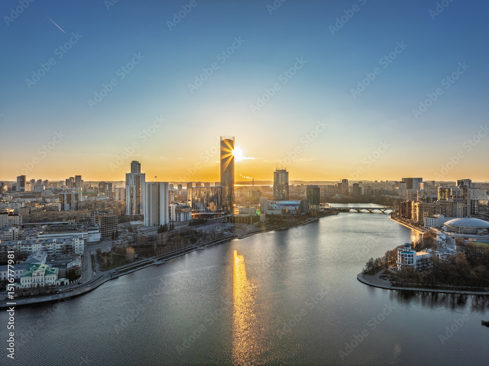 Fototapeta premium Yekaterinburg aerial panoramic view in spring at sunset. Yekaterinburg city and pond in spring or autumn.