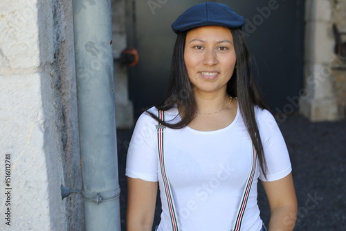Woman wearing suspenders and a vintage hat 