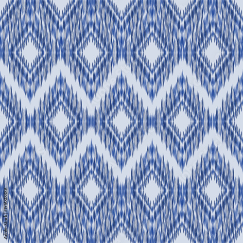 Ikat Seamless Pattern. Geometric diamond ikat pattern in rich indigo tones offers a modern take on traditional weaving techniques.Ikat Abstract.Great for backgrounds, packaging, and textile surfaces.