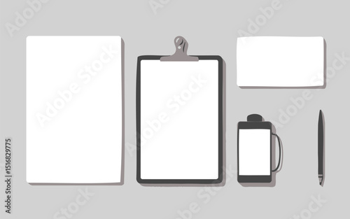 Top view of stationery items including paper, clipboard, and writing utensils on a gray surface