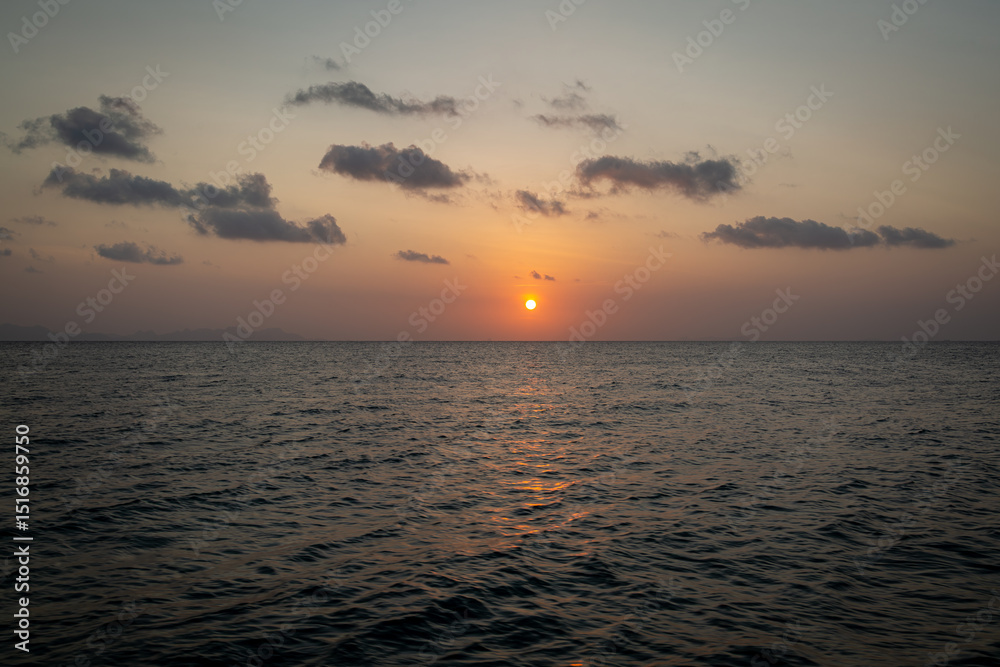 Naklejka premium Sunset in the gulf of Thailand, Image shows a nice calm sea during golden hour with a sky full of colour and few clouds