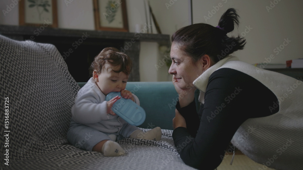 Fototapeta premium Mother gently leaning towards baby, sharing intimate and playful moment during bonding, encouraging early childhood communication and exploration, nurturing home environment