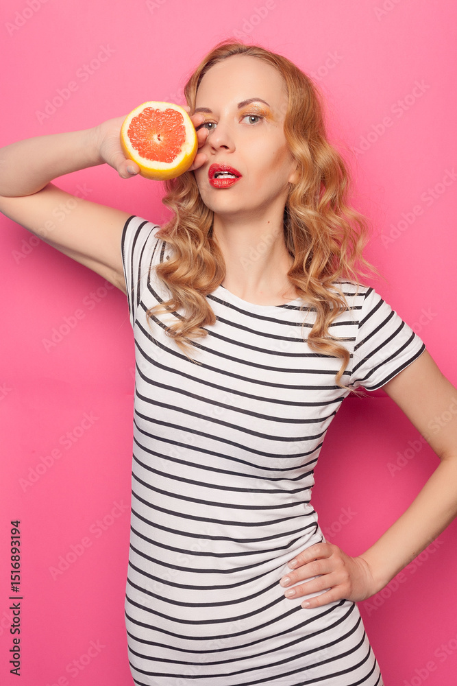 Funny young girl with halfs of fresh ripe grapefruit orange Funny young girl with halfs of fresh ripe grapefruit orange