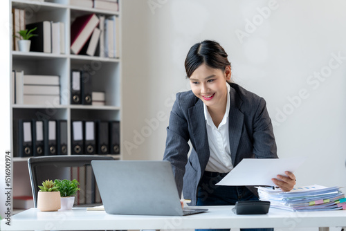 Vászonkép Smiling Asian Businesswoman Working at Desk