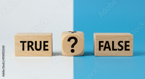 Three wooden blocks displaying true question mark and false on a split color background surface view