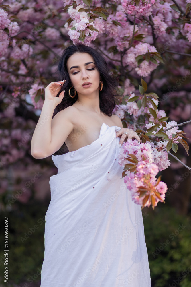 Young woman through the evening streets wrapped in a blanket. Young woman through the evening streets wrapped in a blanket.