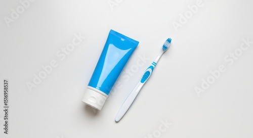 Toothbrush and blue toothpaste tube on white background