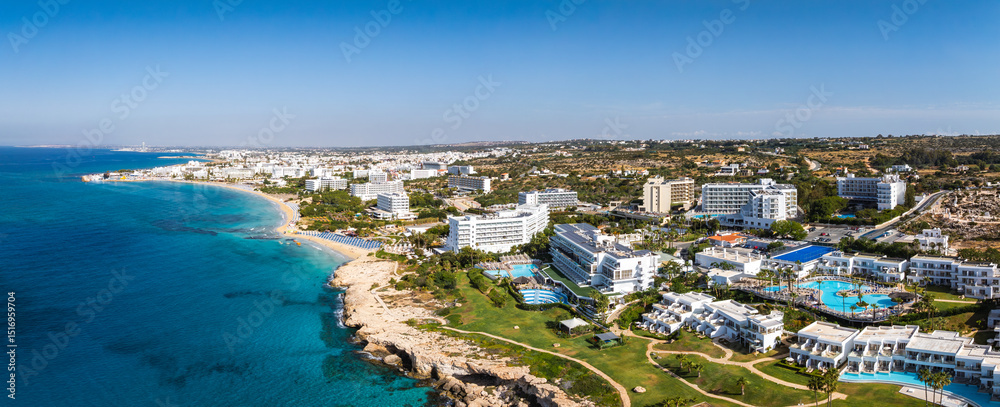 Fototapeta premium Aerial view of Ayia Napa, Cyprus, showing turquoise waters, sandy beaches, luxury resorts, Nissi Beach, Landa Beach, and urban greenery.