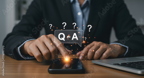 Businessman finger touching mobile phone screen with digital Q and A popup question mark and virtual assistance interface
