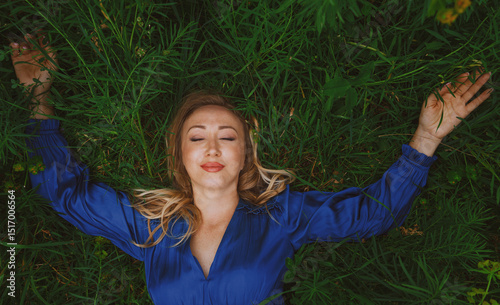 Blond woman enjoying serenity in grassy field
