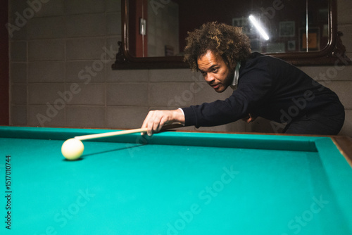 Man playing pool in a modern coworking space