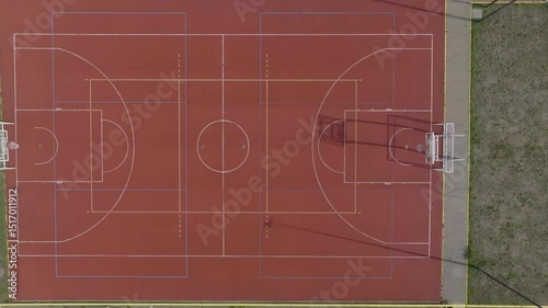 Red Basketball Court from Top-Down Drone Perspective photo