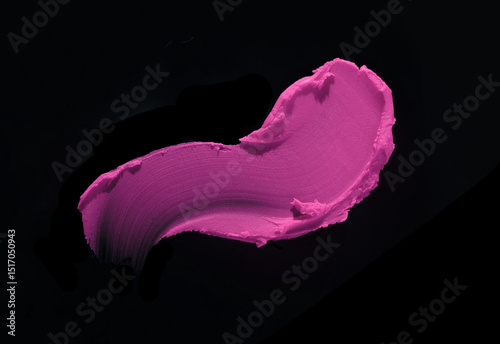 Cosmetic beauty make up product swatch sample . Lipstick smudge purple fuchsia claret colored isolated on black background