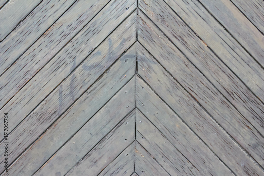 Fototapeta premium Close-up view of gray wooden roof shingles arranged in overlapping chevron pattern showing traditional roofing construction materials