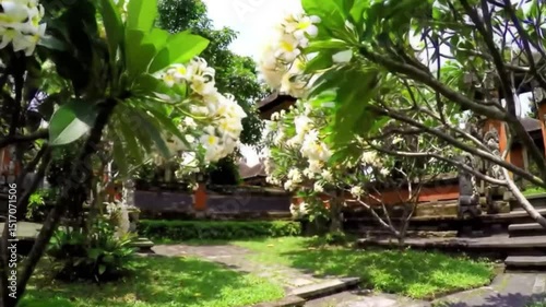 Serene Tropical Garden: A lush tropical garden abundant with vibrant flowers, lush greenery, and traditional architectural elements. Inviting pathways wind through the serene landscape.