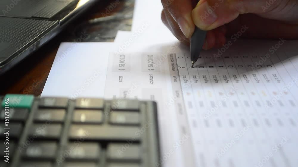 To-Do List and Task List Concept. Close-up businessman checks or marks with pen on a checklist, checkbox, to-do list box after completing a task on a white paper. 
Checking boxes with a pen 