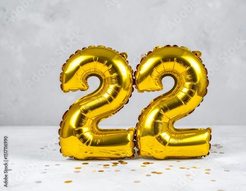 Yellow foil balloon number, number twenty-two on a concrete background. 22th birthday card.