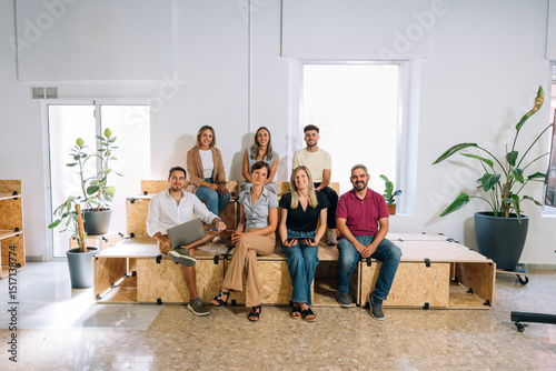Startup team members sitting together in their workspace