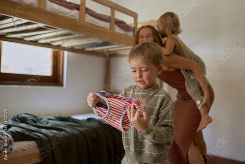 A boy pretending to shoot with a toy gun photo