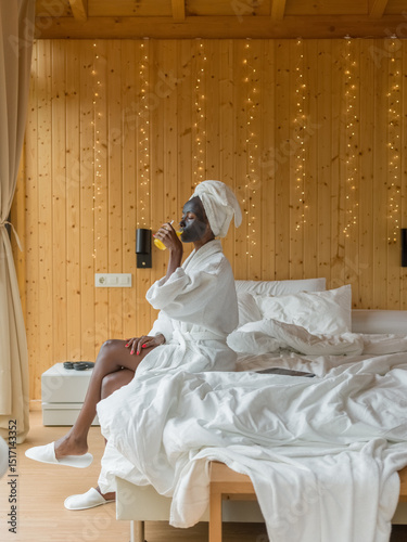 Hotel guest drinking juice in room 