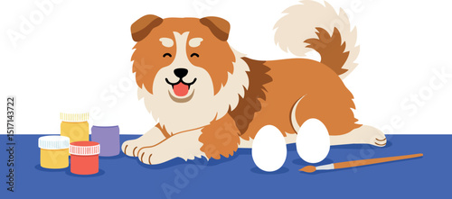 Brown and white dog lying on blue mat with paint jars and brush art supplies 