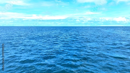 The aerial drone captures the immensity of the tropical sea, with its deep blue hues blending seamlessly into the horizon, creating a serene and boundless vista. Thailand.
