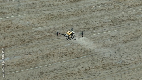 A modern agricultural drone sprays pesticides with precision over rice fields, enhancing efficiency, sustainability, and crop health through innovative automated farming technology.
