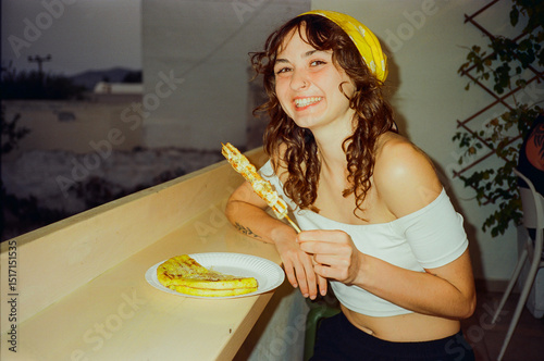 Woman eating souvlaki during vacation in Greece  photo