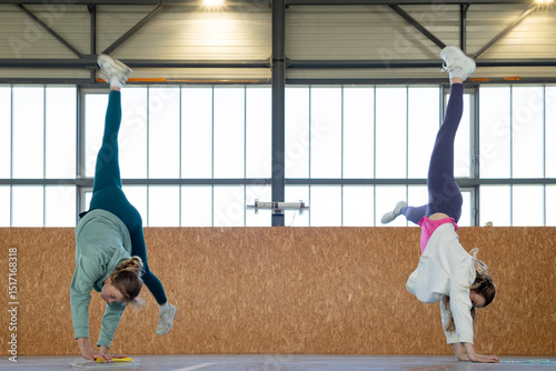 Girls Having fun training synchronized movements in gymnasium  photo