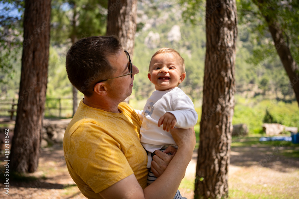 Dad holding a baby in his arms. Dad holding a baby in his arms.