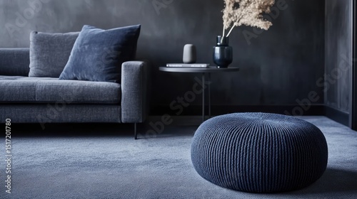 Modern living room interior design featuring a dark blue pouffe and sofa.