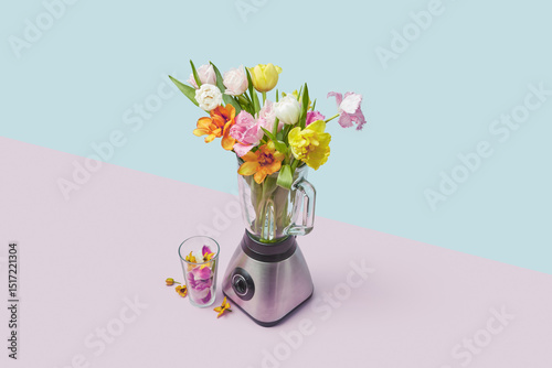 Colourful arrangement of seasonal blossoms placed in blender photo