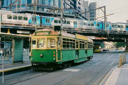 Historic Vintage Green Tram in with a modern metro in Melbourn