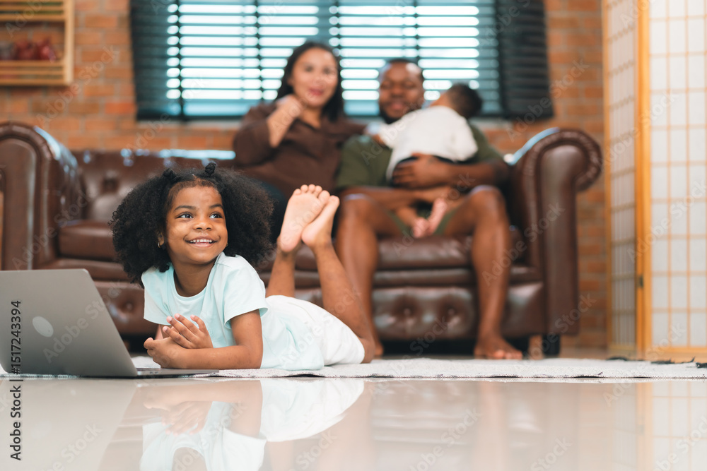© chokniti - Heartwarming family moment as an African American father and daughter share playful time together on the couch, surrounded by love, laughter, and the warmth of home, while mom gently looks on with joy © chokniti - Heartwarming family moment as an African American father and daughter share playful time together on the couch, surrounded by love, laughter, and the warmth of home, while mom gently looks on with joy