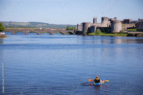 kayaker on the River Shannon in Limerick, Ireland with view of King John's castle