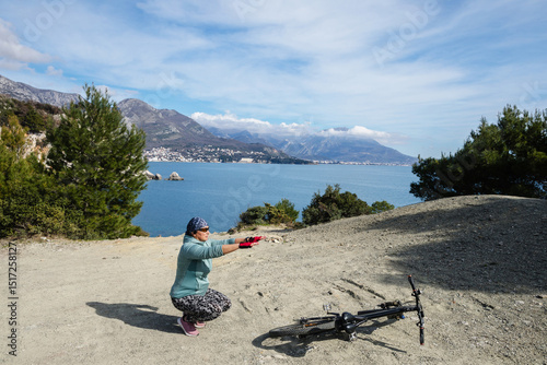 Woman cyclist exercising on the sea coast