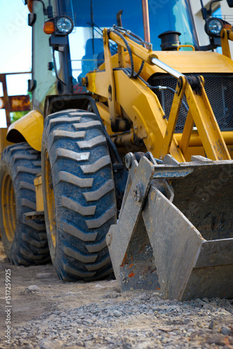 construction excavator heavy equipment tractor loader yellow earthmoving site machine digging dirt