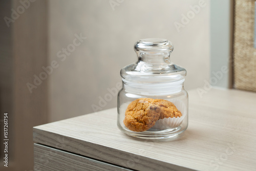 A single jar on the desk holds a couple of cookies, evoking a calm, homely vibe and the promise of a comforting snack.