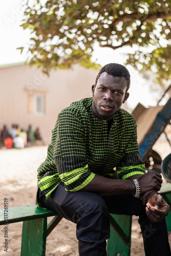 Senegalese man sitting and posing in a village in Africa