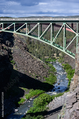 View of the steel arch of the old highway over historic crooked river gorge bridge in central Oregon, scenic day for spring travel
